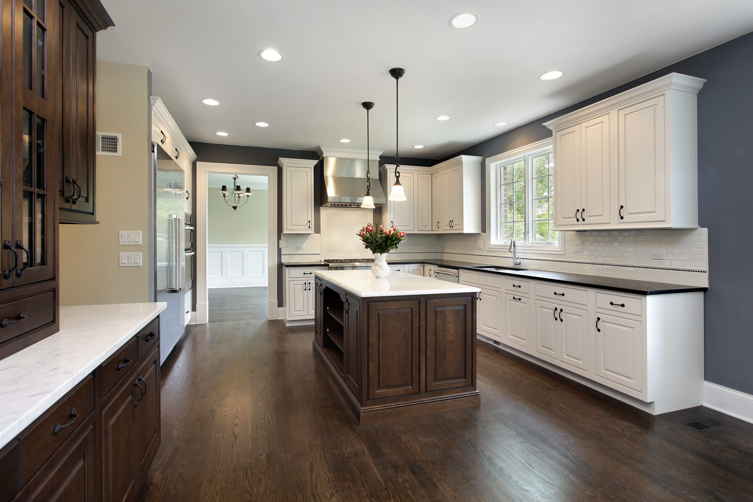 Modern kitchen in a residential home with white and brown cabinets.